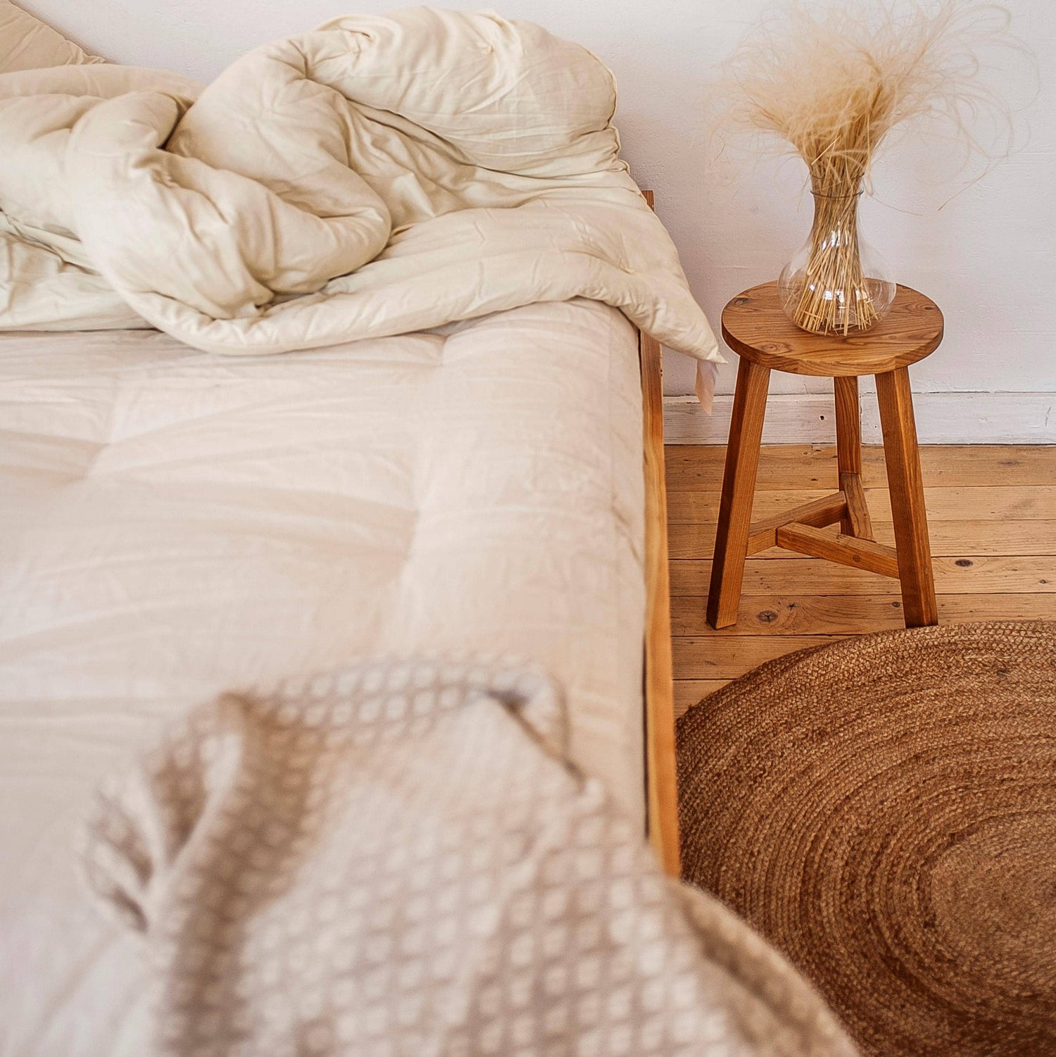 Solid wood bed with mattress and bedding
