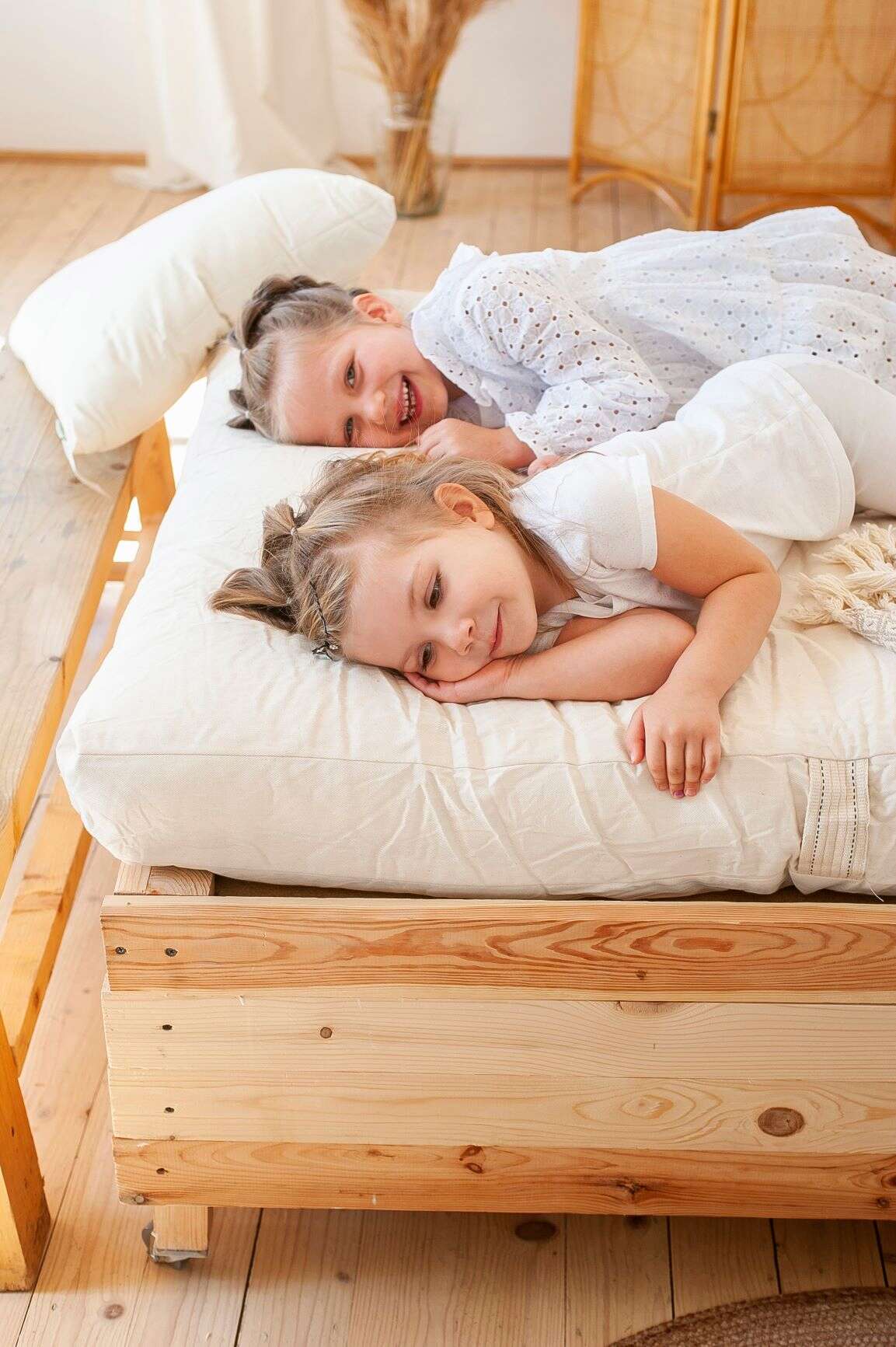 Kids laying on a futon mattress