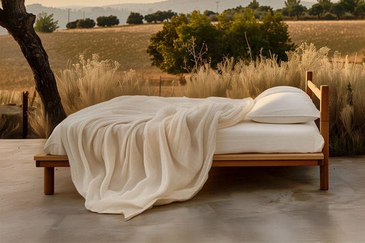Organic cotton and wool bedding layers on a made bed