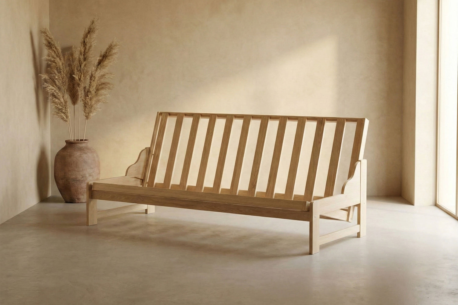Wooden futon frame in a minimalistic room with a vase and dried plants
